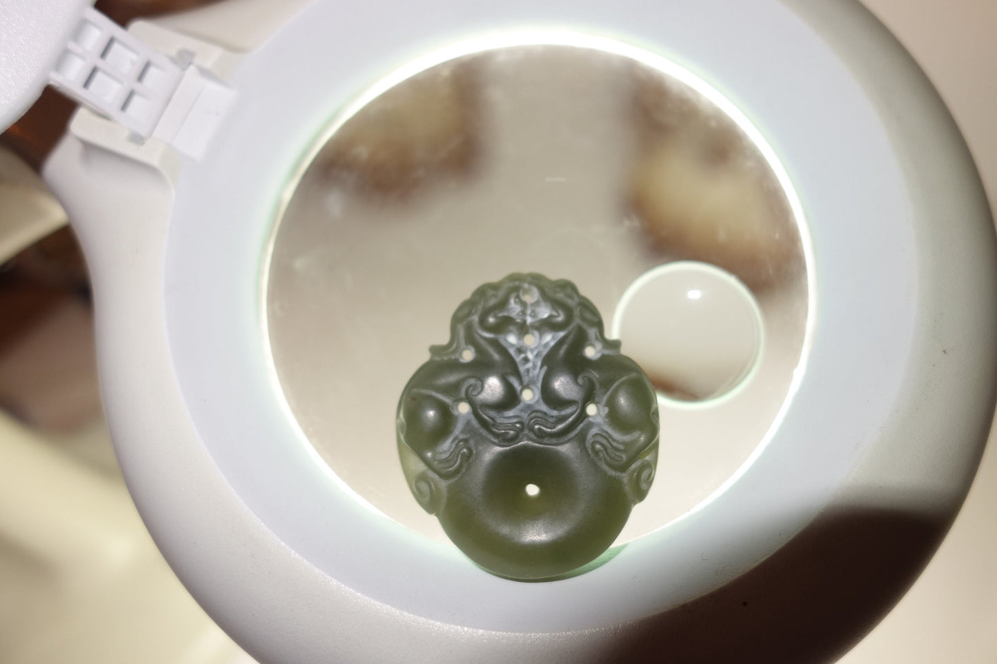 A Chinese agate carved pendant, depicting two dragons