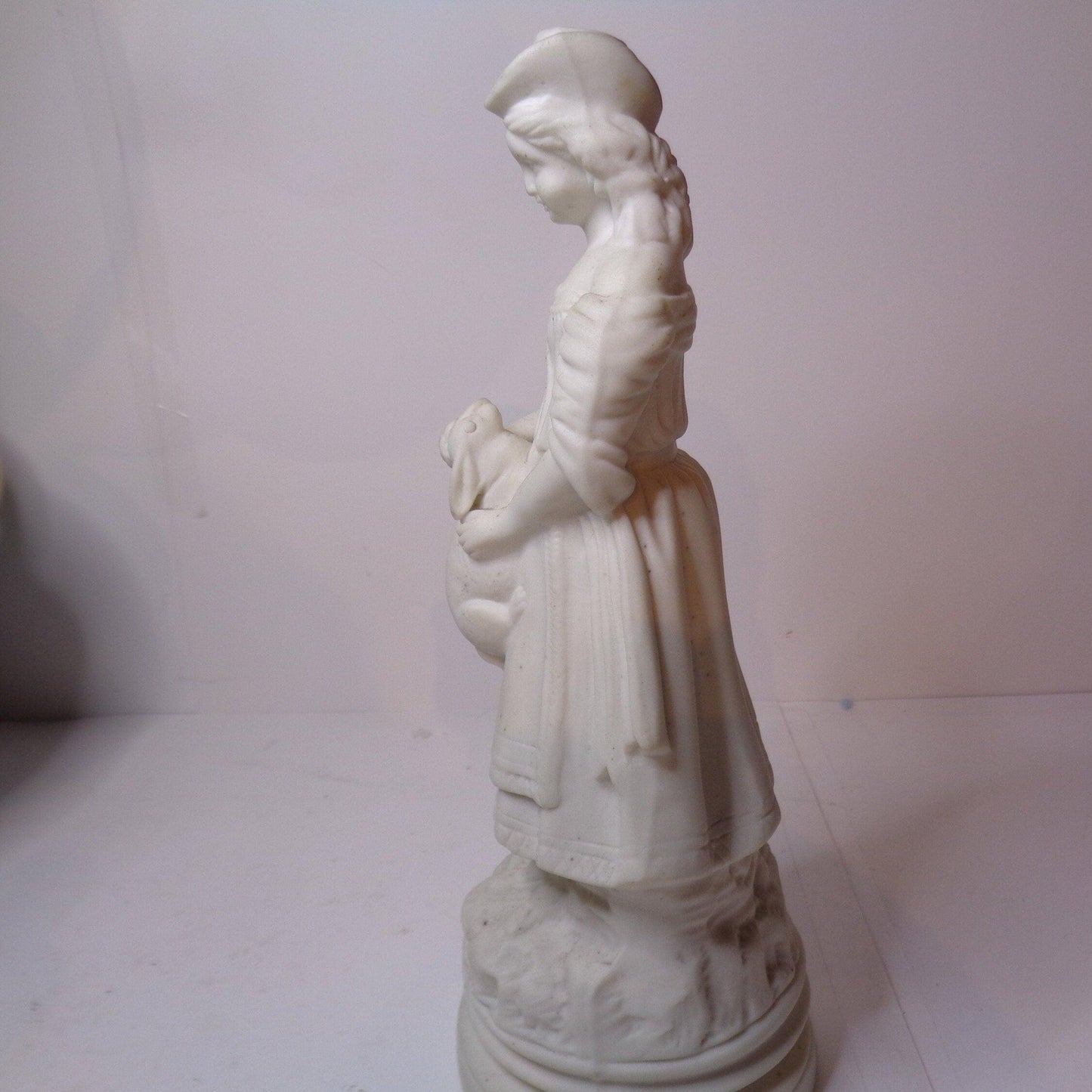 Biscuit porcelain figure of a Victorian girl with rabbit