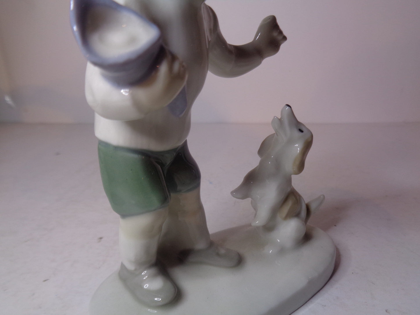 Continental figure of a boy playing with his dog