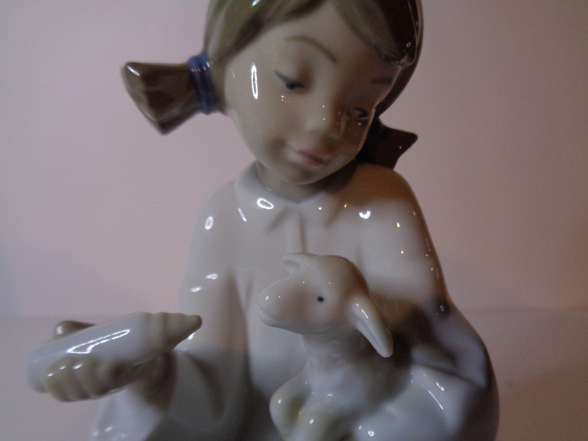 NAO by Lladro Young Shepherdess bottle feeding a lamb