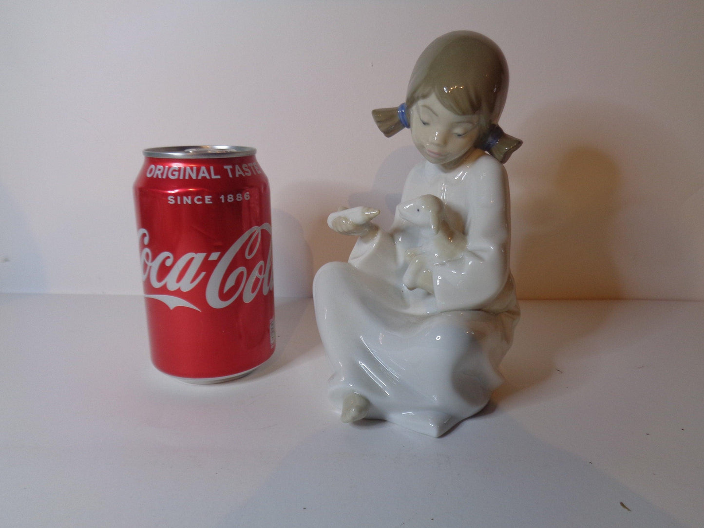 NAO by Lladro Young Shepherdess bottle feeding a lamb