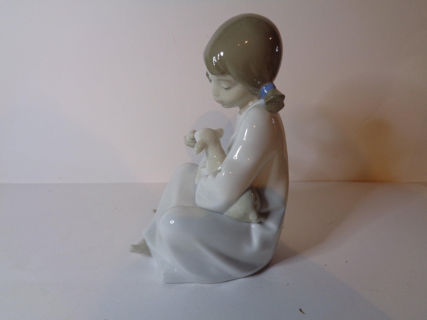 NAO by Lladro Young Shepherdess bottle feeding a lamb