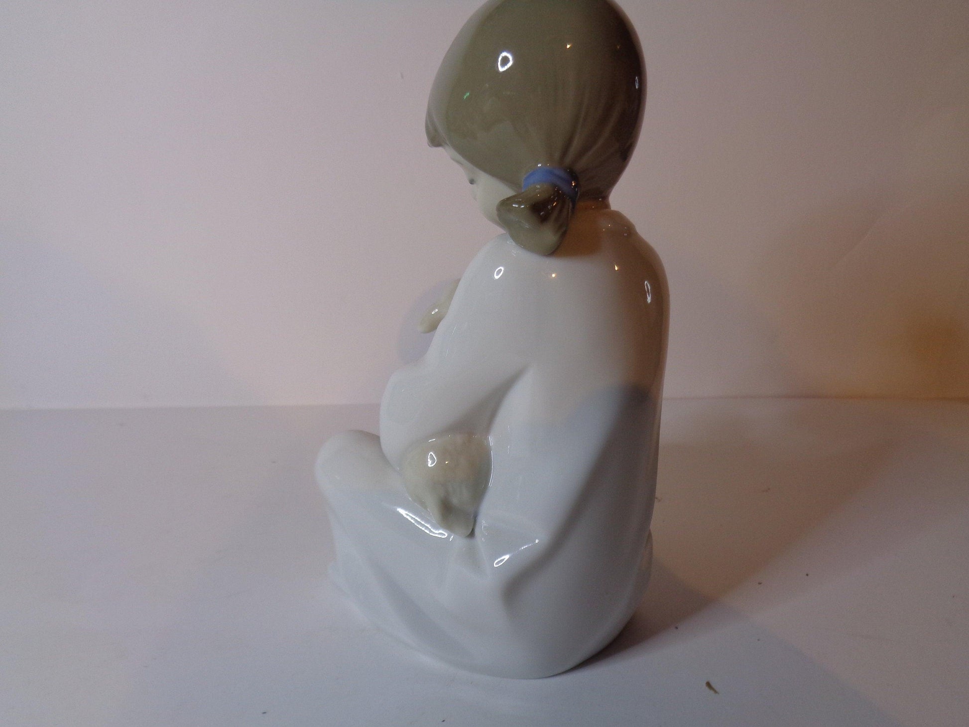 NAO by Lladro Young Shepherdess bottle feeding a lamb