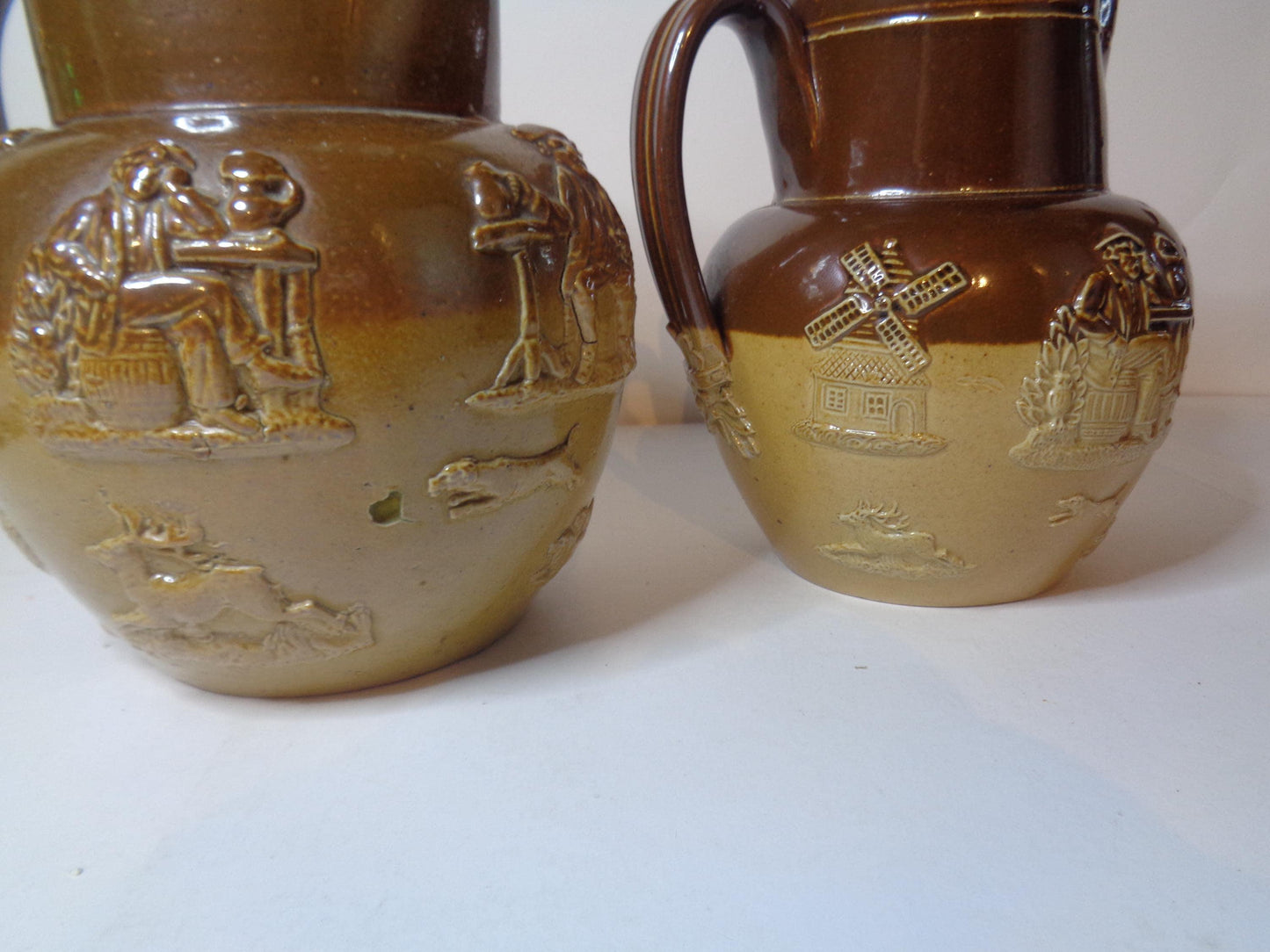 Doulton Lambeth Pair Salt Glazed Harvest Pattern Jugs