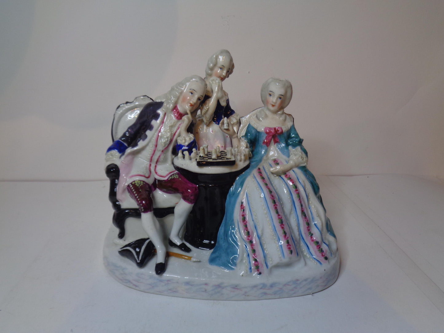 Dresden porcelain figure group featuring a gentleman and lady playing chess