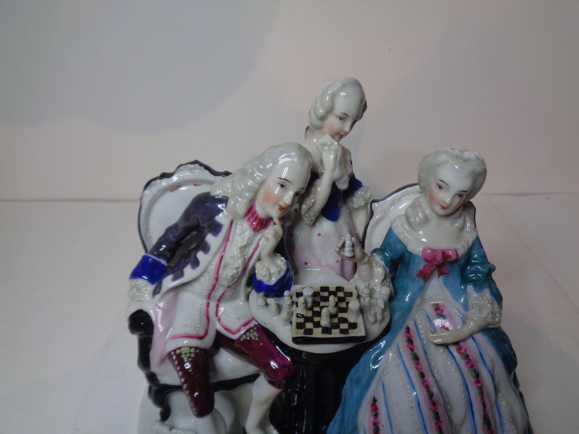 Dresden porcelain figure group featuring a gentleman and lady playing chess