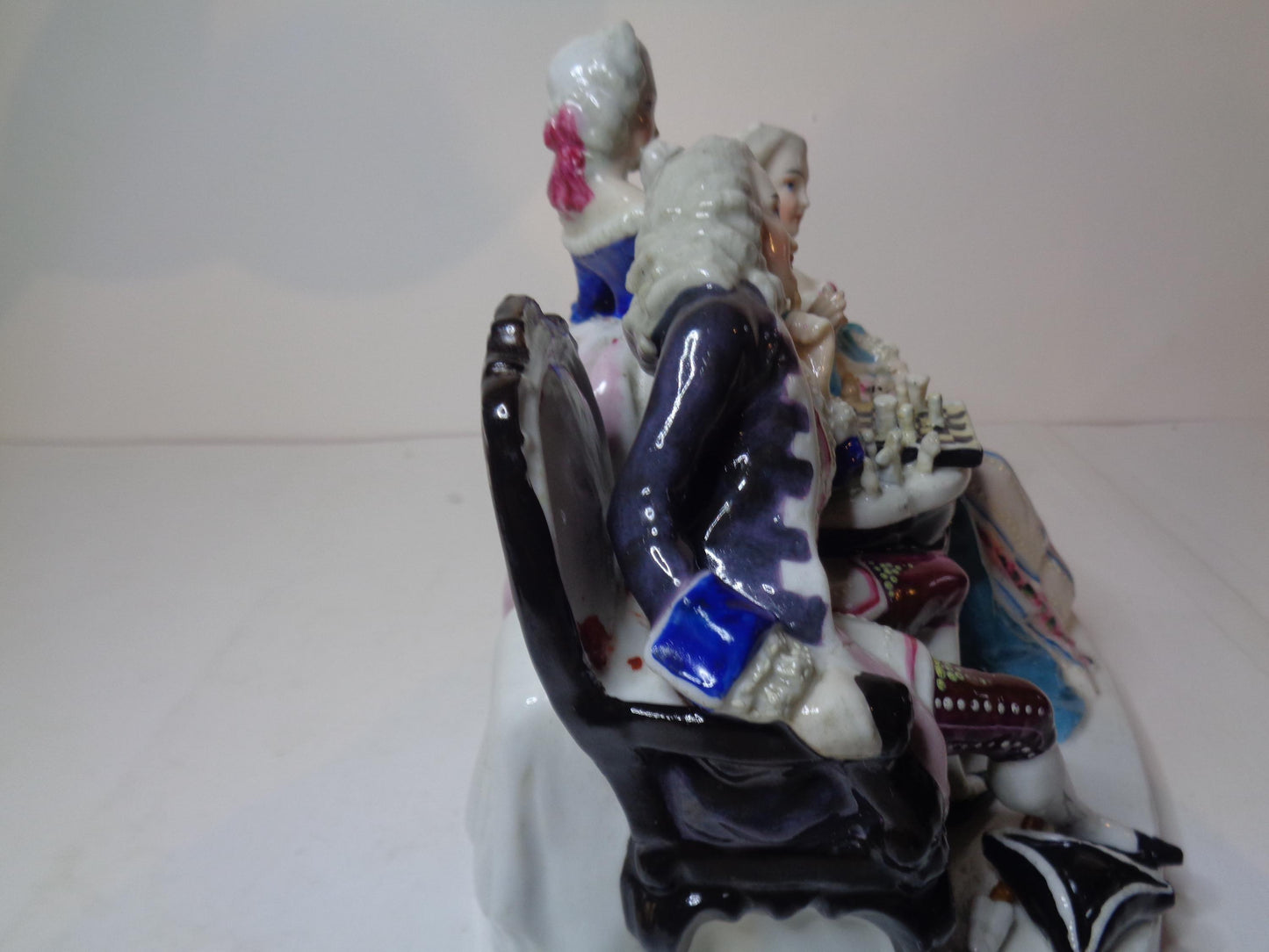 Dresden porcelain figure group featuring a gentleman and lady playing chess