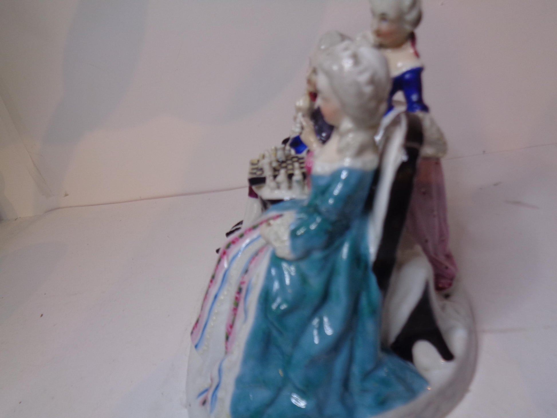 Dresden porcelain figure group featuring a gentleman and lady playing chess